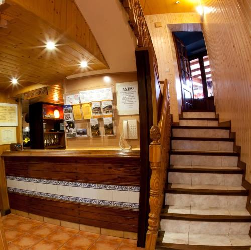 a stairway leading to a store with a staircase at Hotel Sarao in Escarrilla