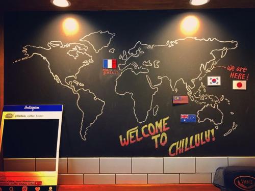 a map of the world on a wall at Chillulu Hostel in Yokohama