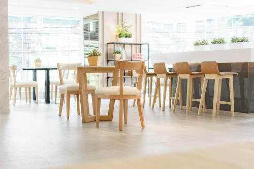 a dining room with a table and chairs at Kritthai Residence in Bangkok