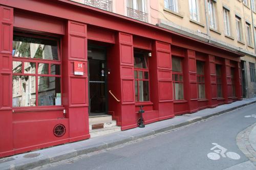 a red building on the side of a street at Hotel Saint Vincent in Lyon
