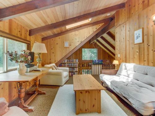 a living room with a couch and a table at The Chalet on Lopez in Islandale