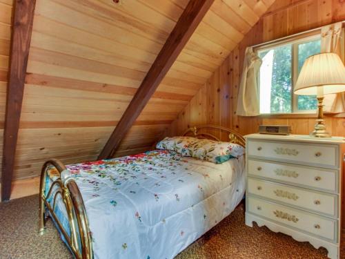 a bedroom with a bed and a dresser and a window at The Chalet on Lopez in Islandale
