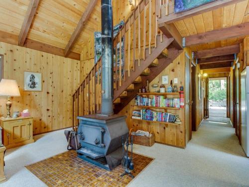 a living room with a woodburning stove in a house at The Chalet on Lopez in Islandale