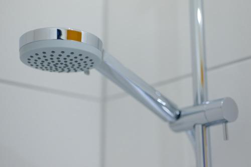 a shower head in a bathroom at McDreams Hotel Essen in Essen