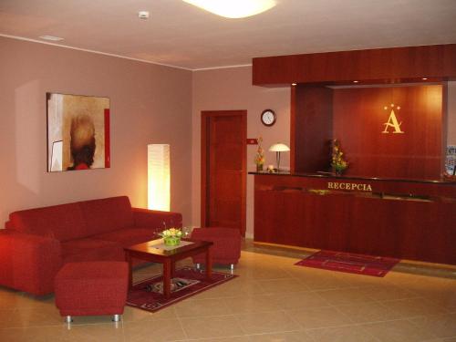 a living room with a couch and a table at Hotel Altenberg in Staré Hory
