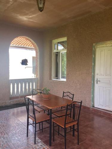 a table and chairs in a room with a window at Guest House Marani in Sighnaghi