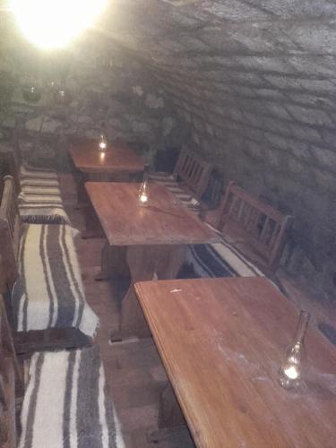 a room with wooden tables and chairs in a cave at Réka Vendéghàz in Tokaj