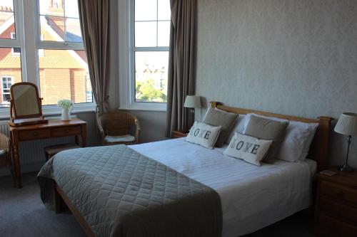 a hotel room with a bed with two pillows at Beamsley Lodge B&B in Eastbourne