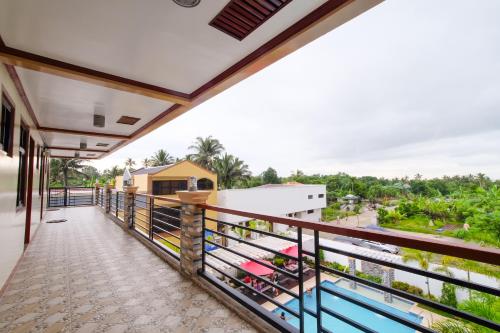 a balcony with a view of the street at Hotel Georgina in Maitim