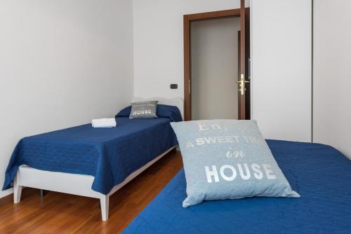 a bedroom with a bed with a blue comforter and a pillow at Ortaglia B2 in Torri del Benaco