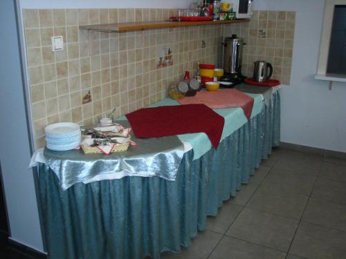 a table in a kitchen with a blue table cloth at Willa Victoria in Szklarska Poręba