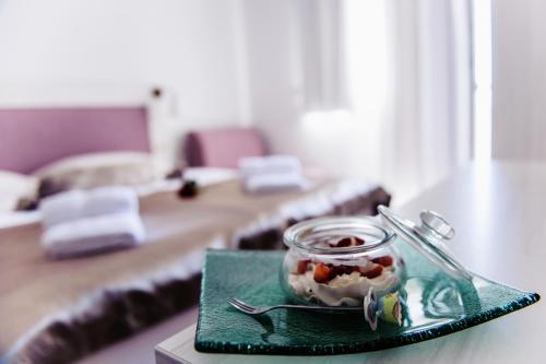a table with a plate with a glass jar of food at Villa Palloma in Baška Voda