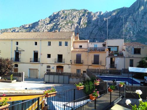 a group of buildings with a mountain in the background at Can Misse in Collbató