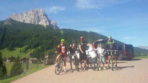 a group of people on bikes on a road at Garni La Majon in Selva di Val Gardena