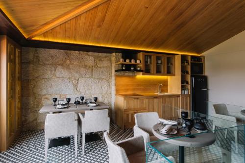 a dining room with a glass table and chairs at Casa do Rio charm suites in Vila do Conde