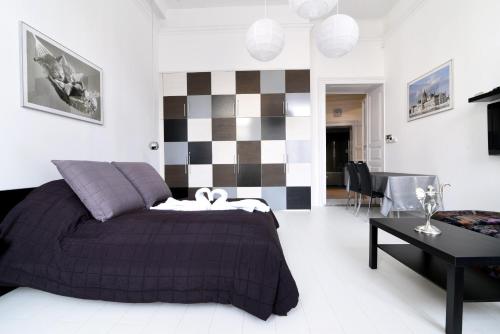 a bedroom with a bed and a checkerboard wall at Downtown Deluxe in Budapest