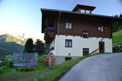 a house on the side of a road with a trampoline at Oberrainbauer in Kleinarl