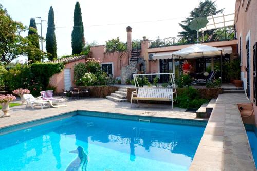 a swimming pool in front of a house at Casa Felice in Passo Corese