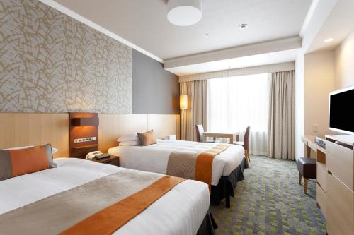 Кровать или кровати в номере Shibuya Excel Hotel Tokyu