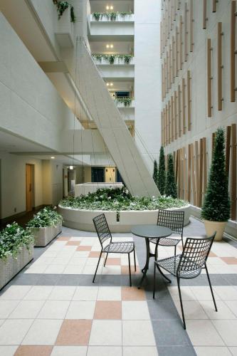 a courtyard with a table and chairs in a building at Hotel Lumiere Nishikasai in Tokyo