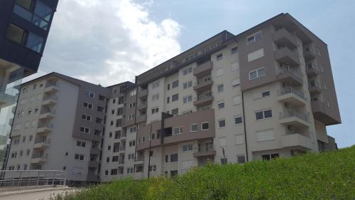 a large apartment building in front of a building at Turistic Apartments Centar Sarajevo in Sarajevo