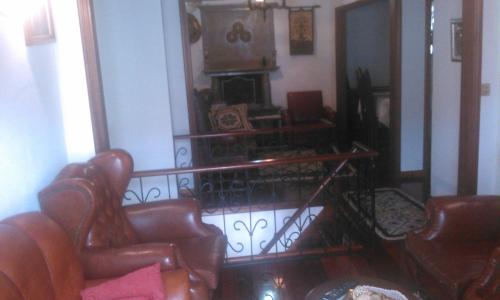 a living room with two chairs and a fireplace at Alfazema in São Sebastião