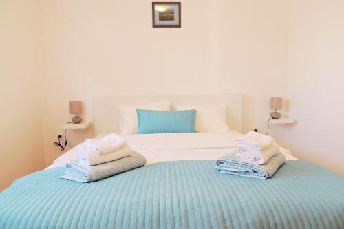 a bedroom with a bed with towels on it at Private accommodation KIRINCIC in Vrh