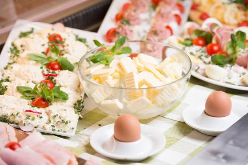 a table topped with plates of food with eggs at Privat u Babky in Ždiar