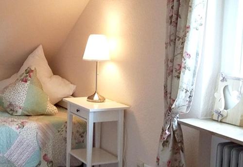 a bedroom with a bed and a lamp on a night stand at Gasthaus Zur Linde in Oberharmersbach