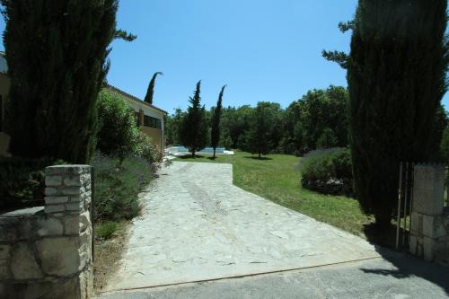 a stone path leading to a house with trees at Villa Breg in Labin