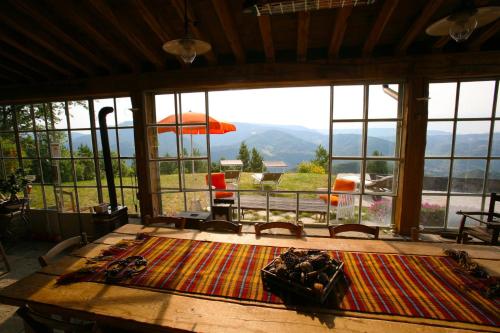 a room with a table with a view of the mountains at b&b LATORDICELLA in Castel del Rio