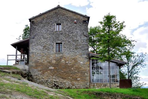 an old stone house on top of a hill at b&b LATORDICELLA in Castel del Rio