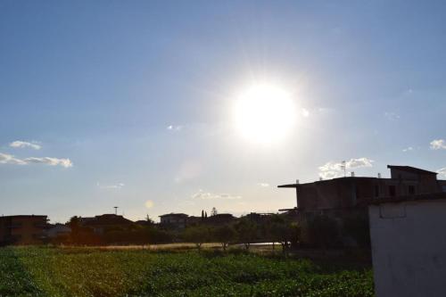a sun shining in the sky over a field at Tenuta Ferrara in Altavilla Silentina