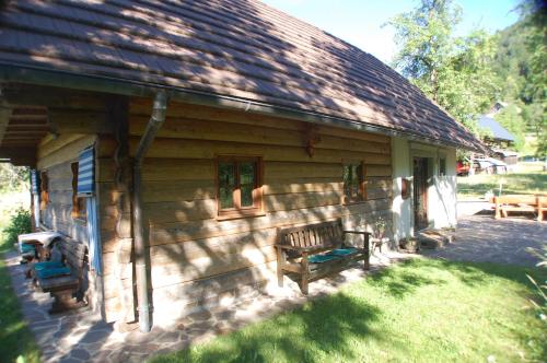 a bench sitting outside of a log cabin at Chalet ApArt Kupljenik 12 A, Bled in Bohinjska Bela