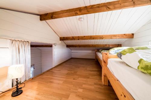 a bedroom with two beds and a wooden floor at Geysir Hestar in Haukadalur
