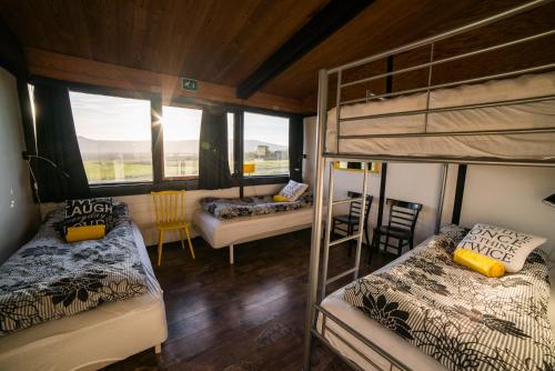 a bedroom with two bunk beds and a window at Geysir Hestar in Haukadalur