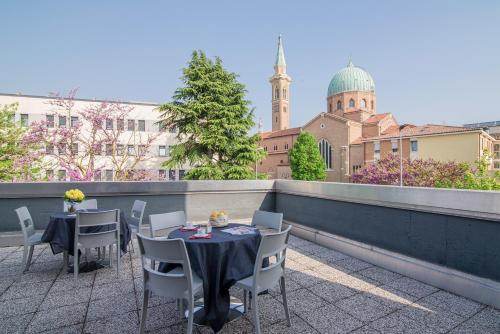 two tables and chairs on a rooftop patio at Casa Lucia Valentini Terrani in Padova