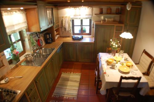 a kitchen with a table with a white table cloth at Chalet ApArt Kupljenik 12 A, Bled in Bohinjska Bela