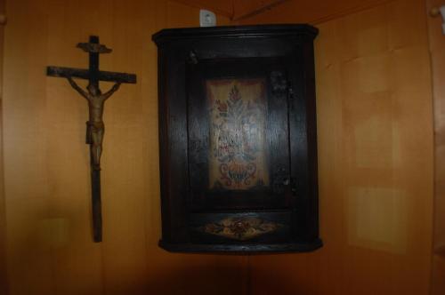 a cross on a wall next to a painting and a crucifix at Chalet ApArt Kupljenik 12 A, Bled in Bohinjska Bela