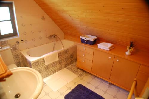 a bathroom with a tub and a toilet and a sink at Chalet ApArt Kupljenik 12 A, Bled in Bohinjska Bela