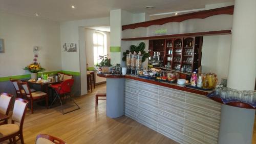 a bar in a restaurant with a table and chairs at Haus Alexander in Heringsdorf