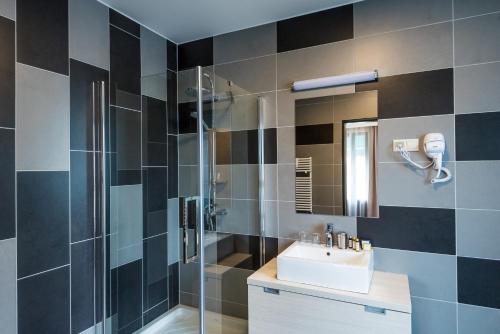 a bathroom with a sink and a shower at Hotel Kamilla in Balmazújváros