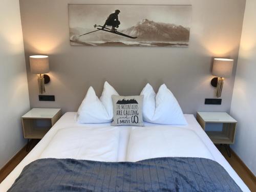 a bedroom with a white bed with a sign on it at Appartement Sunside in Saalbach-Hinterglemm