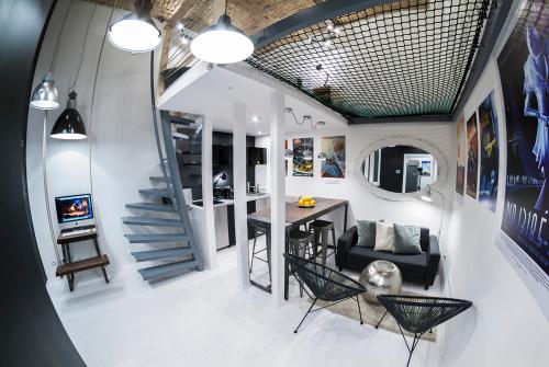 a living room with a staircase and a table and chairs at Designer loft at the Great Synagogue in Budapest