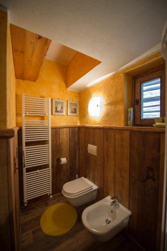 a bathroom with a toilet and a sink at Bellavista Cogne Apartment in Cogne
