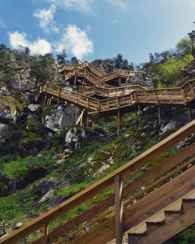 a wooden bridge on the side of a mountain at Quinta da Ribeirinha in Arouca