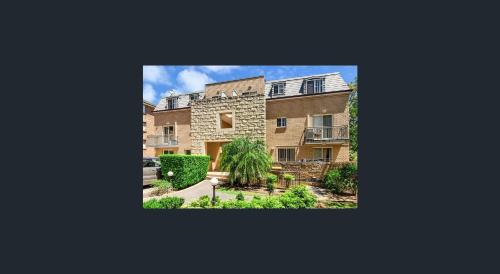 an image of an apartment building with a courtyard at Caulta Apartments in Sydney