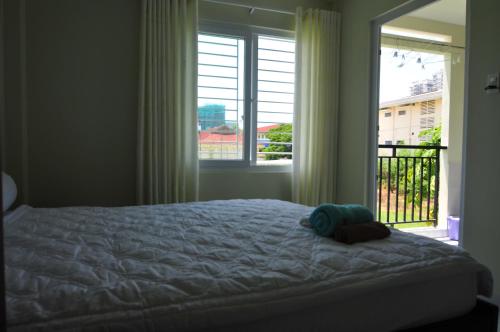 a bedroom with a bed and a large window at Greenfield Nha Trang Apartments for rent in Nha Trang