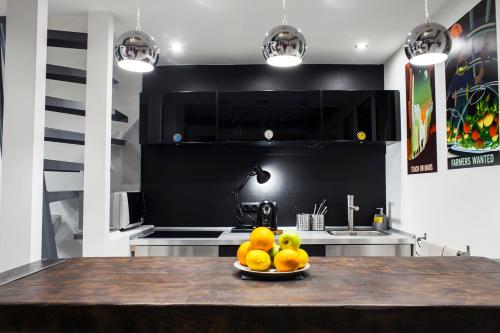 a plate of fruit on a table in a kitchen at Designer loft at the Great Synagogue in Budapest