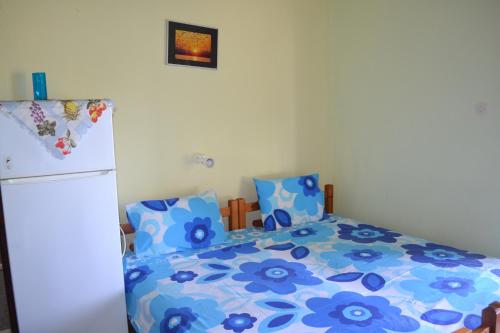 a bedroom with a bed and a refrigerator at House Souzanna in Toroni